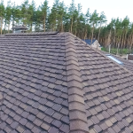 High-angle close-up view of a newly installed brown multi-layered architectural shingle field, demonstrating standard residential choices in the Metal vs Asphalt Roofing debate by Eckstein Roofing Co.