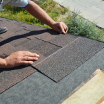 Close-up view of a roofer manually installing an architectural shingle course over protective underlayment during a Storm Damage Roof Repair Cincinnati OH project by Eckstein Roofing.